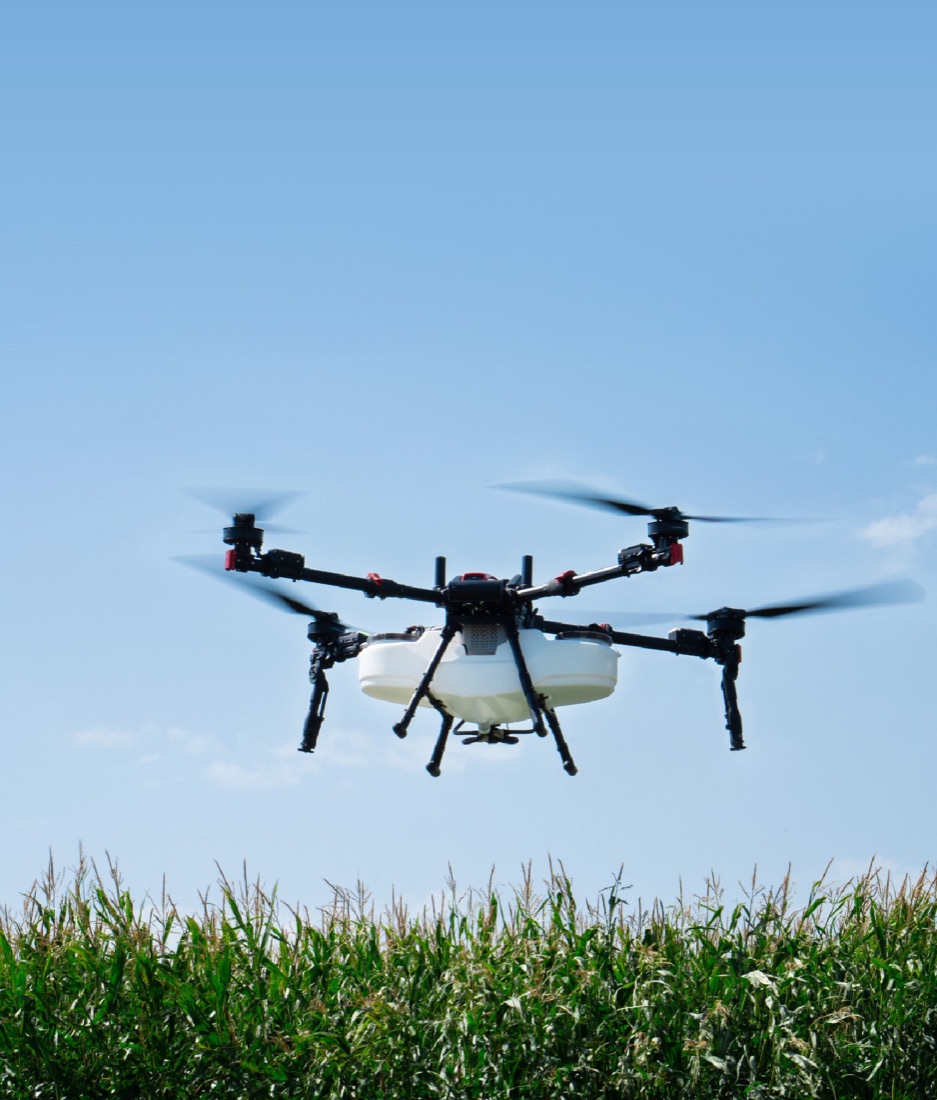 The XAG P150 Max agricultural drone in flight above a corn field